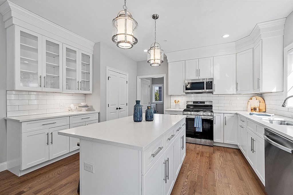 30 Wheeler Hill Road, Unit 61 Berlin, MA 01503 - Photo 4 of 31 a kitchen with cabinets stainless steel appliances a sink and kitchen island