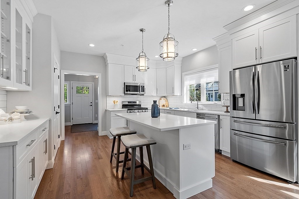 30 Wheeler Hill Road, Unit 61 Berlin, MA 01503 - Photo 5 of 31 a kitchen with stainless steel appliances kitchen island a refrigerator a stove a sink and a stove