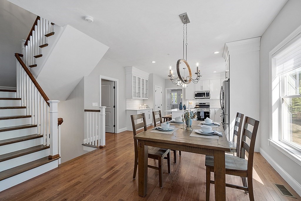 30 Wheeler Hill Road, Unit 61 Berlin, MA 01503 - Photo 8 of 31 a view of a dining room and livingroom with furniture wooden floor a chandelier