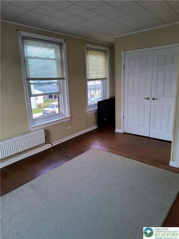 a view of a room with wooden floor