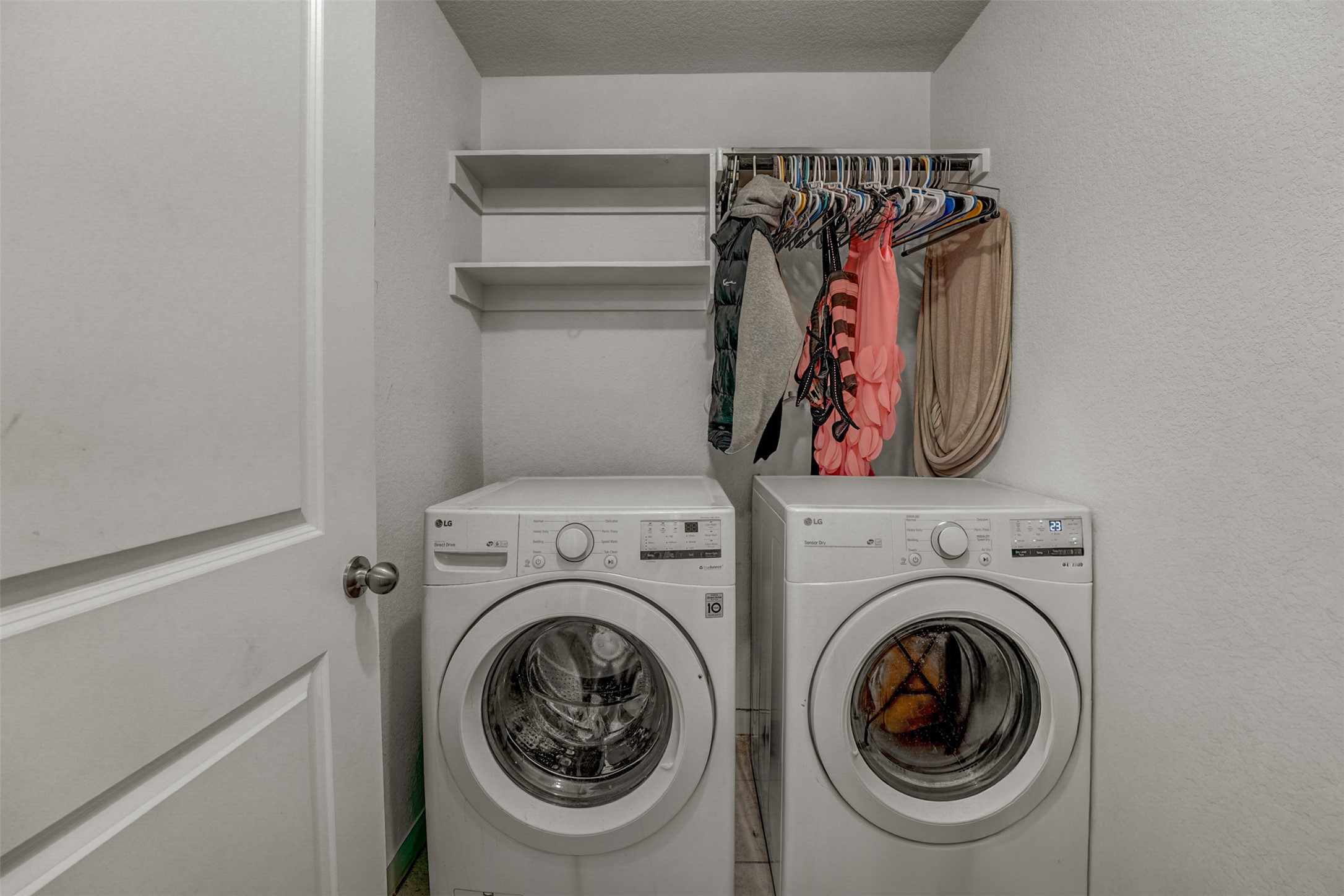 5806 Aviano Road Round Rock, TX 78665 - Photo 29 of 29 Functional laundry space featuring washer and dryer, complete with convenient shelving and a clothing rod.
