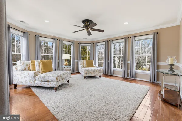 a living room with furniture and large windows