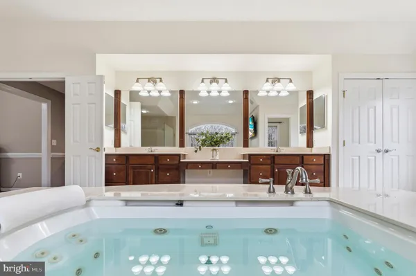 a kitchen with kitchen island granite countertop a sink counter top space appliances and cabinets