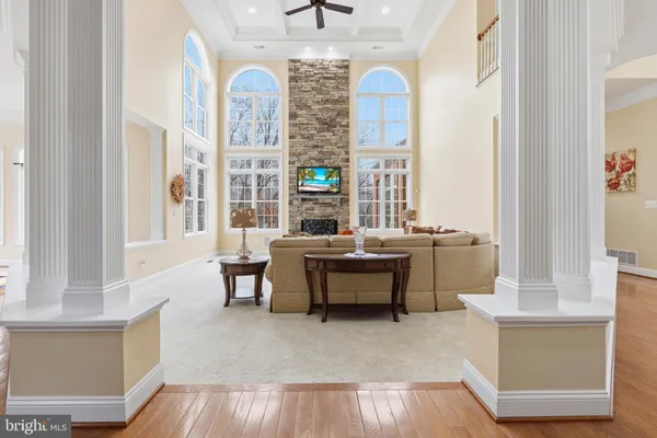 a large kitchen with stainless steel appliances granite countertop a sink a island a stove and a wooden floor