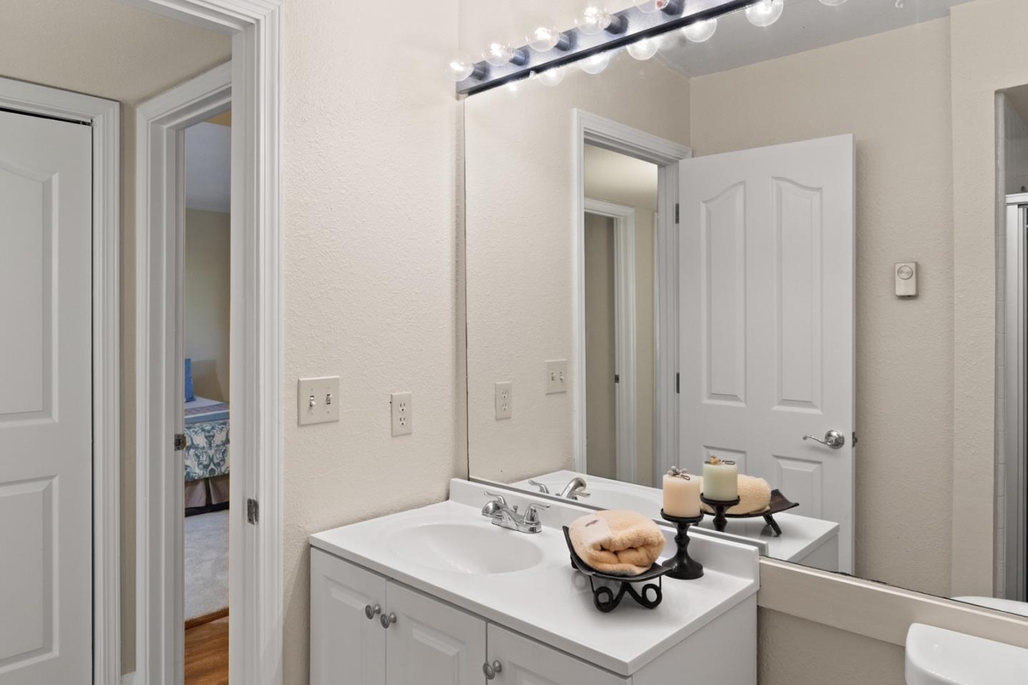 321 Broadway, Unit C2 Santa Cruz, CA 95060 - Photo 20 of 46 a bathroom with a sink vanity and mirror