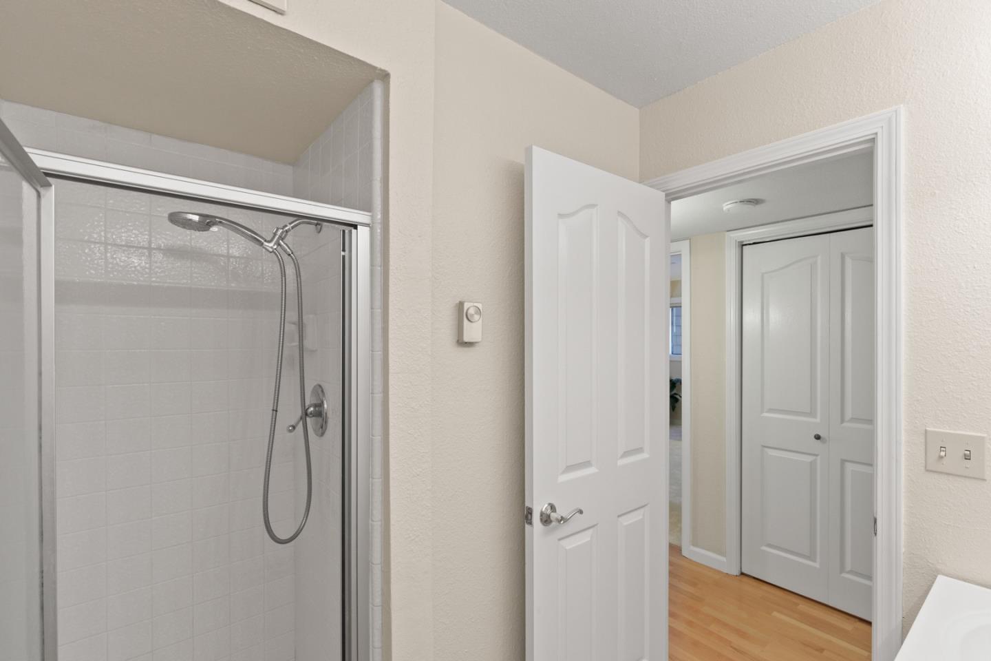 321 Broadway, Unit C2 Santa Cruz, CA 95060 - Photo 21 of 46 a bathroom with a glass shower door and mirror