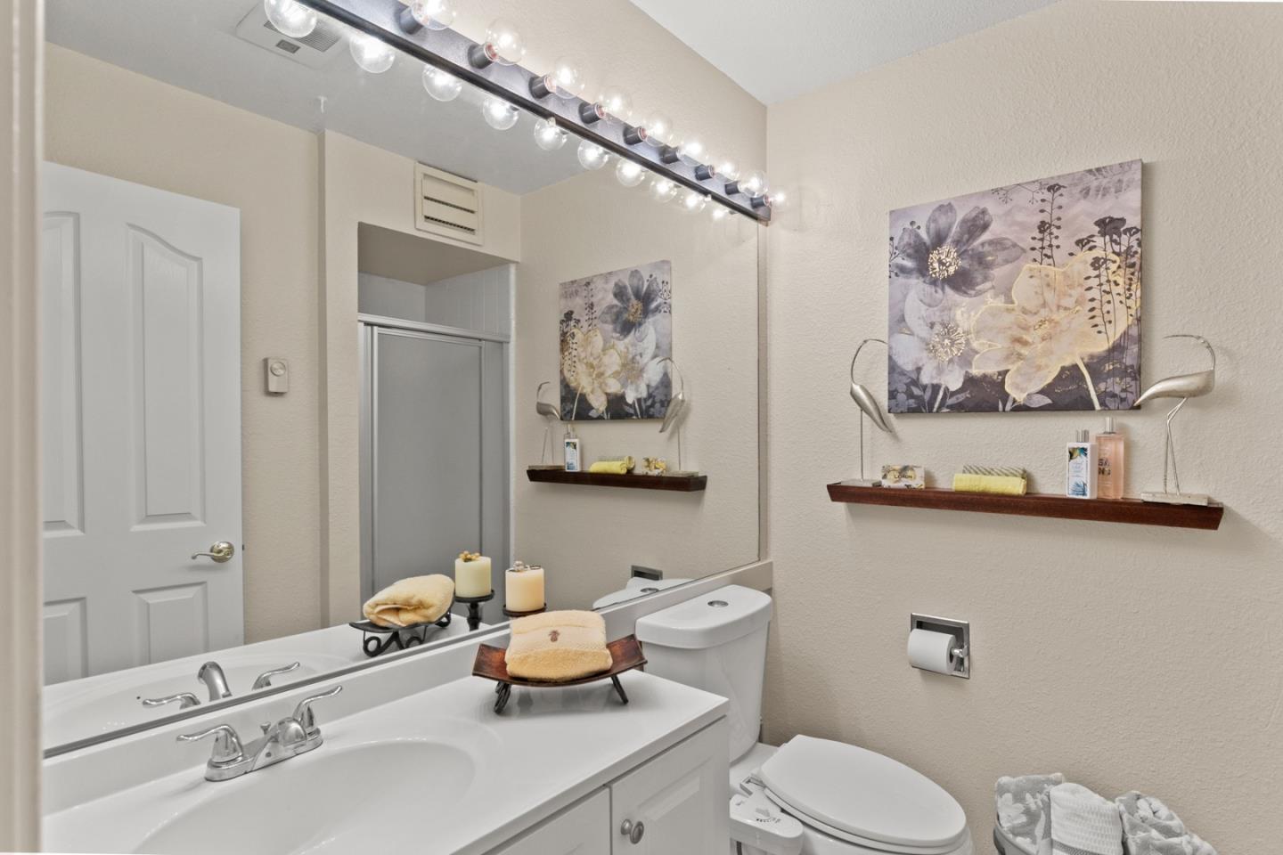 321 Broadway, Unit C2 Santa Cruz, CA 95060 - Photo 22 of 46 a bathroom with a toilet a sink and a mirror