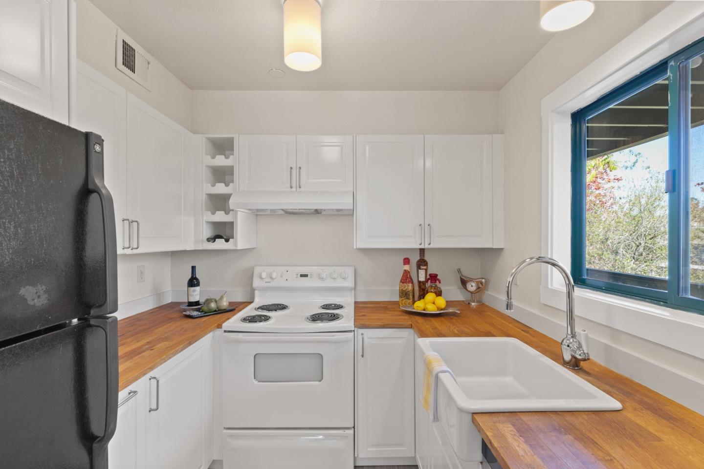 321 Broadway, Unit C2 Santa Cruz, CA 95060 - Photo 9 of 46 a kitchen with a sink stove and refrigerator