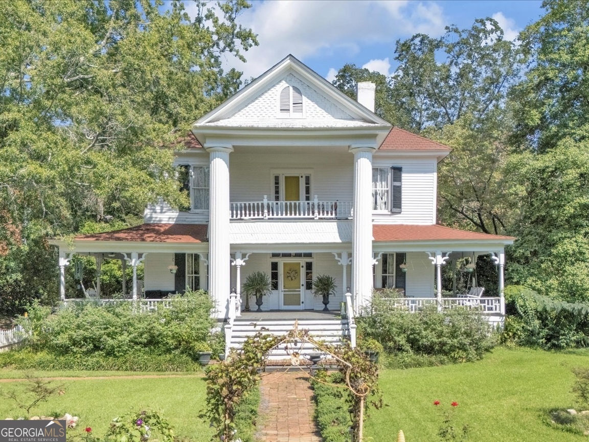 a front view of a house with garden
