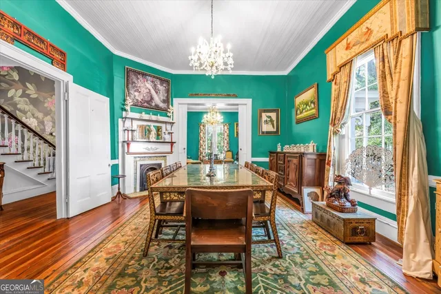 a bedroom with a bed and a dresser next to a window