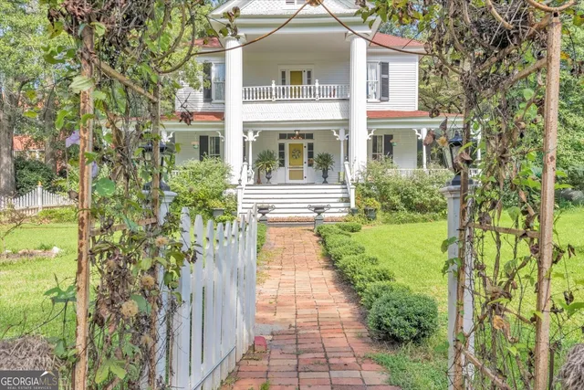 a front view of a house with garden