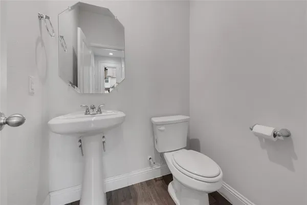 a bathroom with a sink toilet and a mirror