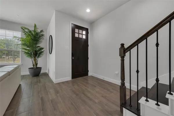 a view of an entryway with wooden floor and door
