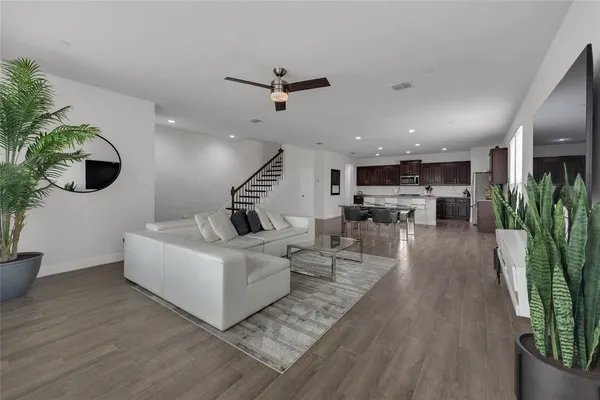a living room with furniture and a potted plant