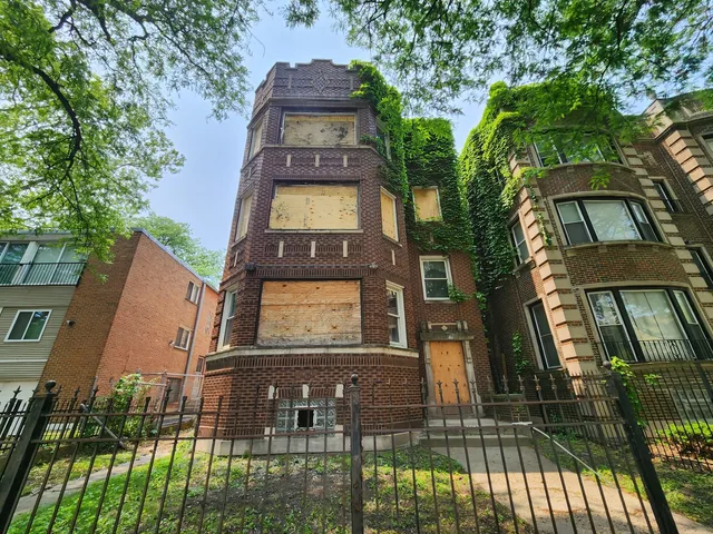 a view of a brick building with large windows