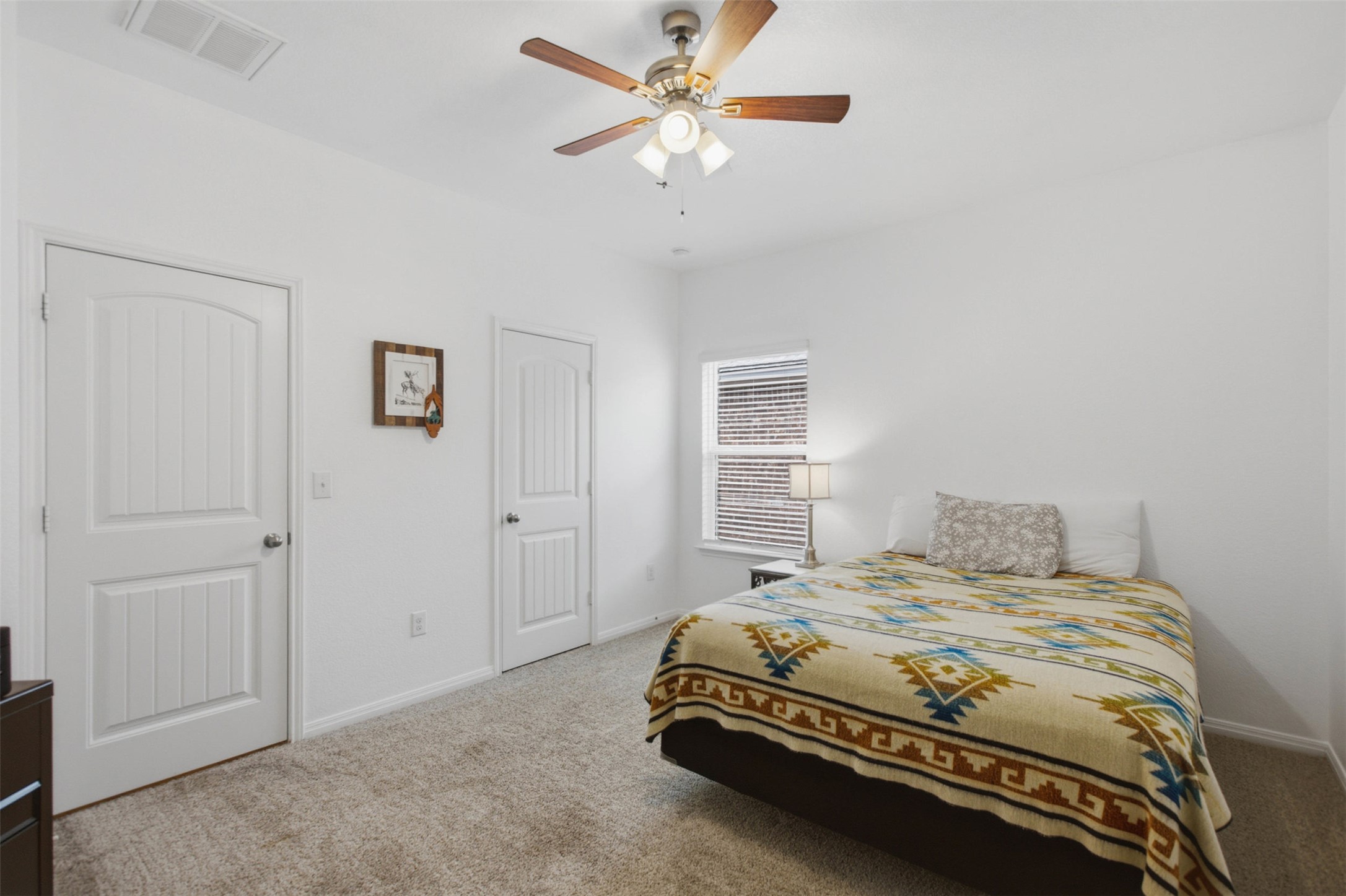2413 Bridges Ranch Road Georgetown, TX 78628 - Photo 20 of 31 Well-lit and functional, this bedroom offers comfortable living with a convenient ceiling fan for optimal airflow.