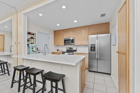 a kitchen with stainless steel appliances a stove microwave and refrigerator