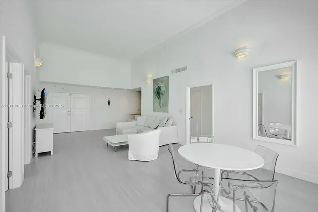 a living room with furniture a table and chair