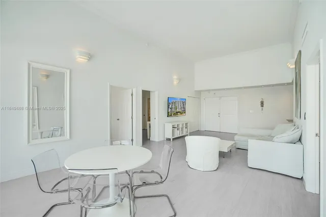 a living room with furniture and a dining table