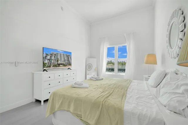 a bedroom with a bed and a night stand