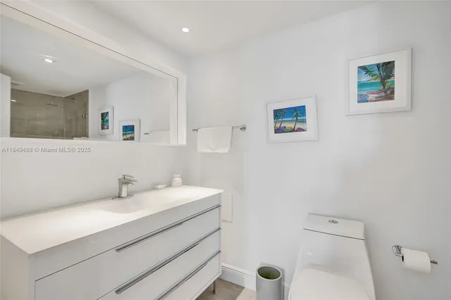 a bathroom with a shower a toilet and sink