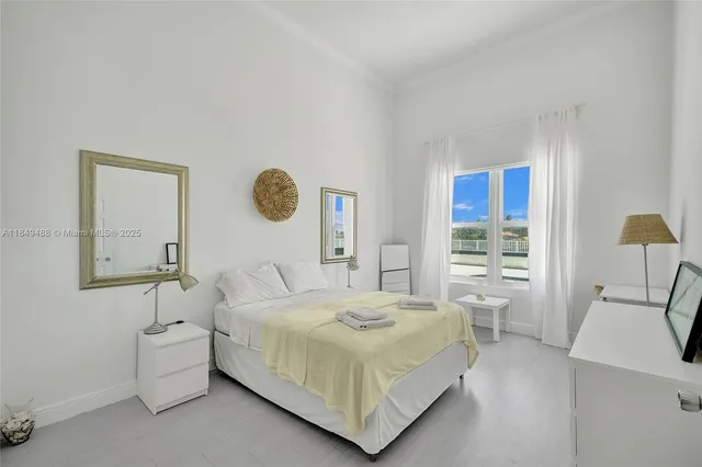 a bedroom with a bed and a mirror