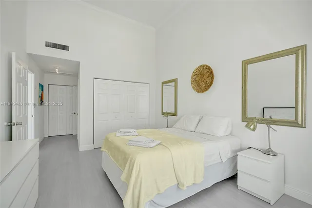 a bedroom with a bed and a mirror