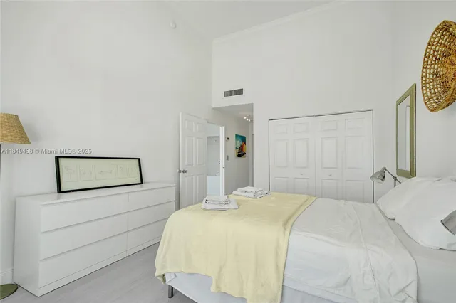 a bedroom with a bed and a lamp