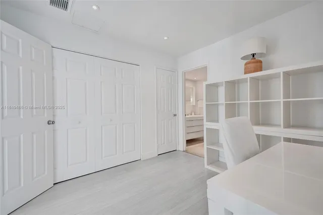 a living room with furniture and a book shelf