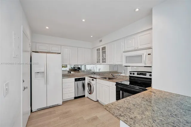 a kitchen with stainless steel appliances granite countertop a stove and a refrigerator