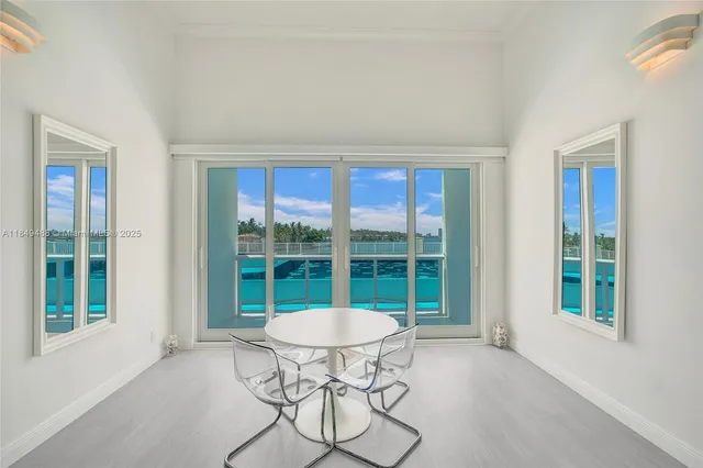 a living room with a mirror and a table