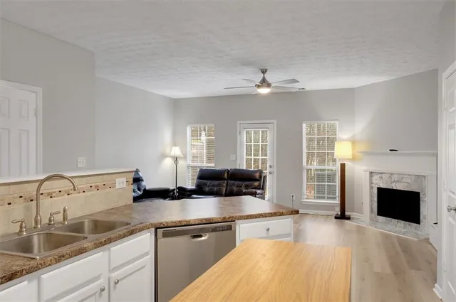 a spacious bathroom with a sink double vanity granite and a fireplace