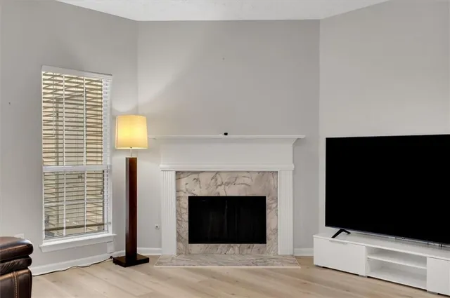 a living room with a fireplace and a flat screen tv
