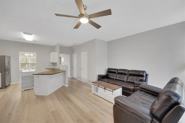 a living room with furniture and a wooden floor