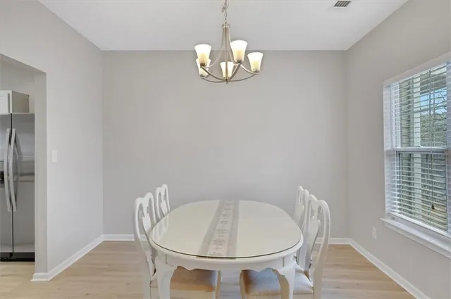 a very nice looking room with a table and chandelier