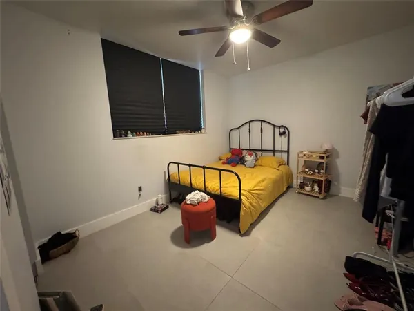 a bedroom with bed and gym equipment