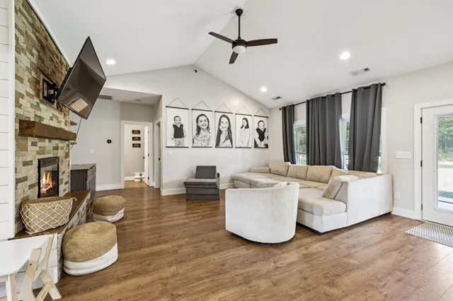 a living room with furniture flat screen tv and a fireplace