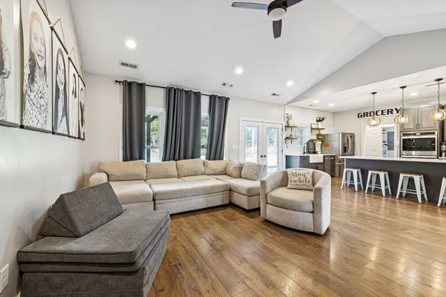 a large kitchen with stainless steel appliances lots of counter space and wooden floor