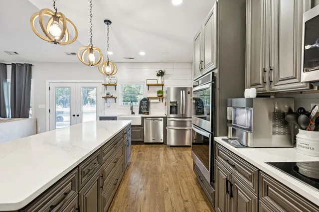 a kitchen with a refrigerator and a sink