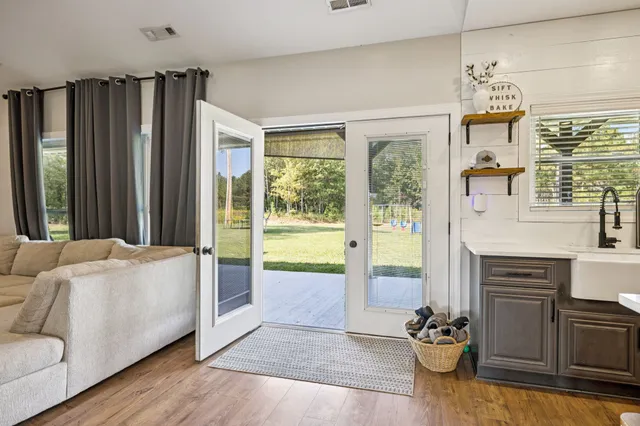 a spacious bathroom with a granite countertop sink and a mirror
