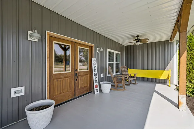a view of a patio with chairs and a table