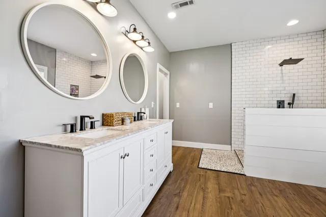 a bedroom with furniture and a wooden floor