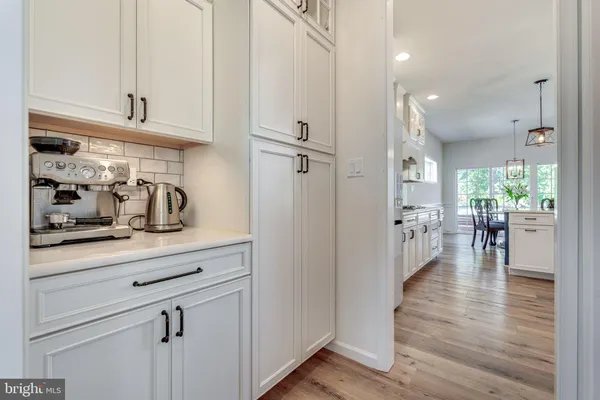 a kitchen with stainless steel appliances granite countertop a refrigerator and cabinets