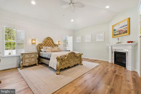 a bedroom with a large bed and a fireplace