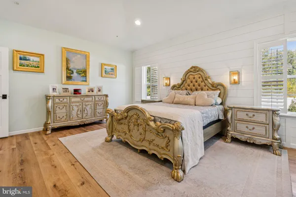 a spacious bedroom with a bed and a couch