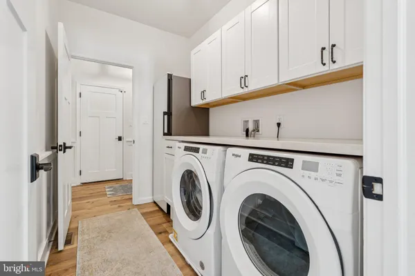 a view of a hallway with washer and dryer