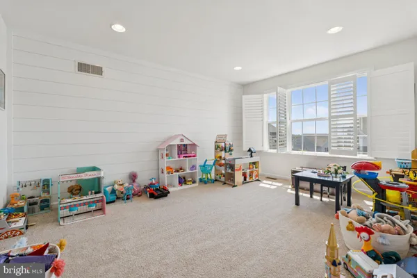 a children room with furniture and a fan