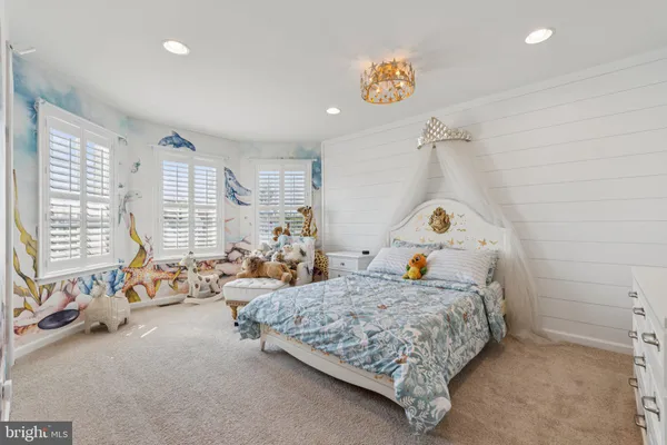 a bedroom with two beds and a large window