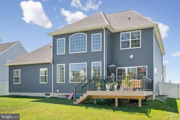 a backyard of a house with yard table and chairs