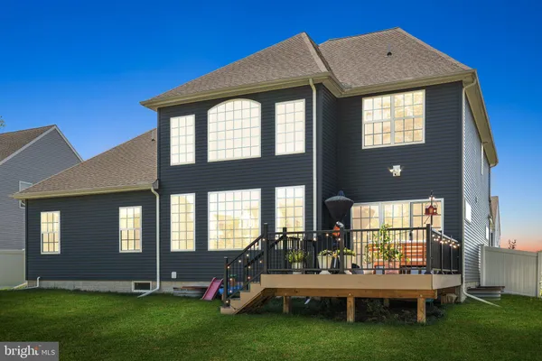a front view of a house with a garden and yard